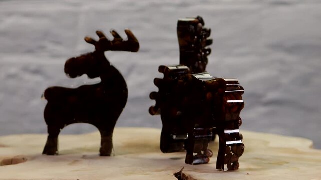 Three elk figures displayed on a rotating turntable. Clean studio footage showcasing animal shapes from multiple angles, ideal for presentations, advertising, product showcases, seasonal themes, and c