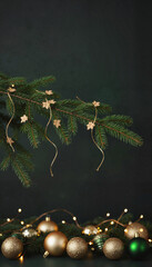 Christmas tree branch with golden ornaments and fairy lights decor  