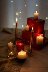 warm ambiance with flickering candlelight and decorated red gift boxes creating a cozy atmosphere, enhanced by soft glowing background lights and elegant textured fabrics, shine, warm, tranquil