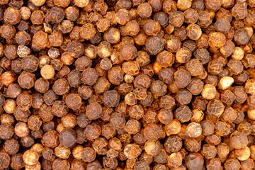 Black peppercorns creating spice food seasoning background texture