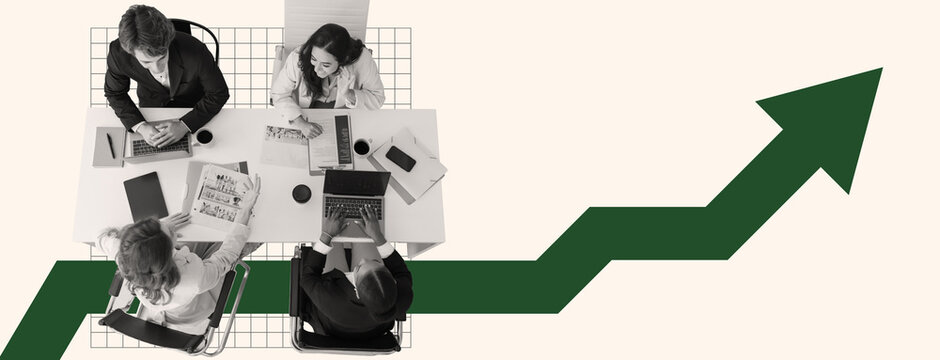 Fototapeta A business team works together around a table, analyzing charts and data on laptops. The atmosphere is focused and collaborative, aiming to increase company growth.