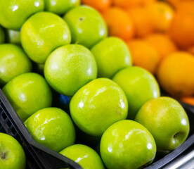 Many of fresh ripe green apples on market, puts out for sale