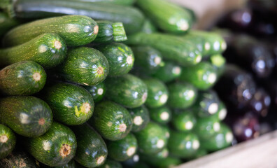 View of zucchini in a wicker basket, put up for sale in a store