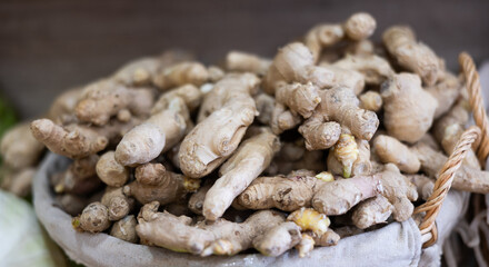 Raw ginger root in a drawer on the counter of a farm store. Fresh ginger for warming drinks. Root vegetables in the supermarket