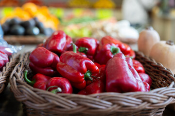 Lot of high quality organic Spanish bell peppers is laid out on shop window. Variations of sweet red bed pepper are presented in greengrocers shop. ..