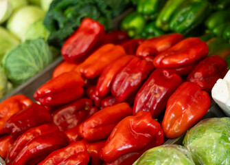 Red bell peppers in shop window. Stocks of fruits in stores storage. Fresh fruit vegetable harvest from producer is already on store shelves.