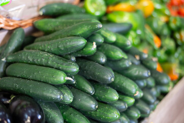 View of cucumbers in a wicker basket, put up for sale in a store