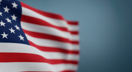 Obraz premium Waving American flag with stars and stripes against a soft blue background