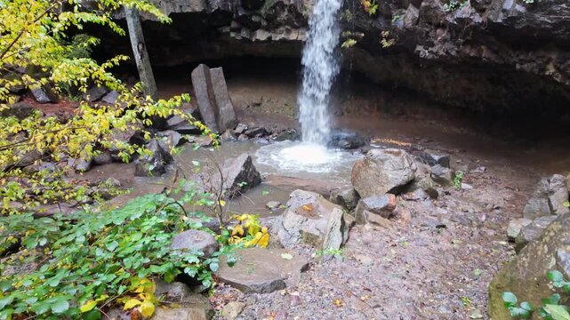 This scenic view captures the unique Hedge Creek Falls waterfall in Dunsmuir, where a short trail allows visitors to walk behind the cascading water