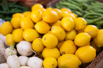 High quality imported eco lemons are grouped in pyramid on shop window. From producers farmer to...
