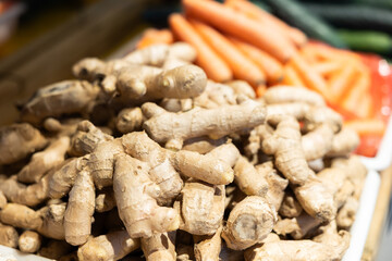 Ginger in shop window. Stocks of fruits in stores storage. Fresh fruit vegetable harvest from producer is already on store shelves.