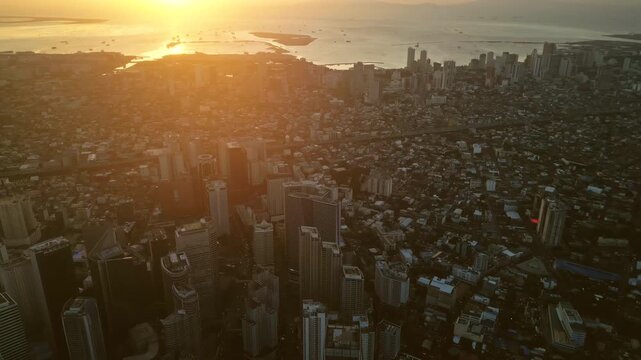 Aerial view of skyscrapers buildings in Makati business district and Manila city at sunset, capital of Philippines, panorama 4k
