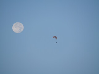 Cairo,Egypt - December 6, 2025: The full moon and Paraglider flying over Pyramid complex in Gaza, Egypt