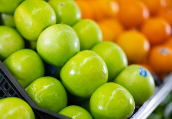 Many of fresh ripe green apples on market, puts out for sale