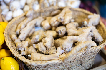 Raw ginger root in a drawer on the counter of a farm store. Fresh ginger for warming drinks. Root vegetables in the supermarket