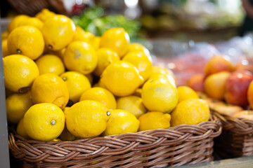 Lemons in shop window. Stocks of fruits in stores storage. Fresh fruit vegetable harvest from producer is already on store shelves.