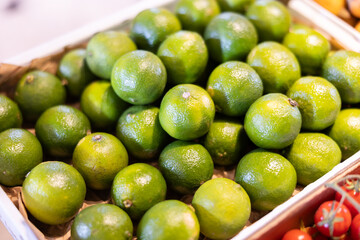 View of limes in a wicker basket, put up for sale in a store