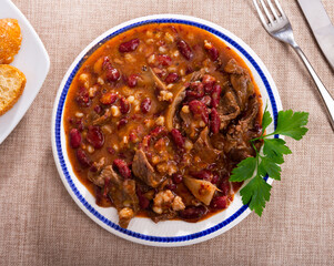Tasty beef with beans and mushrooms closeup