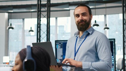 System administrator in office developing software applications, integrating AI driven automation in operations. IT expert using laptop, debugging applications to resolve issues, camera A