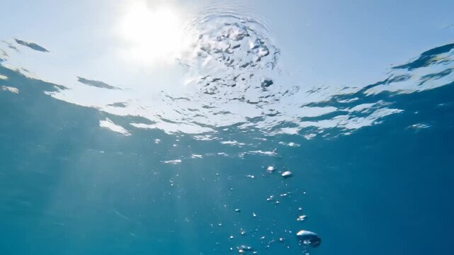 Underwater Perspective Sunlight Penetrating Blue Ocean with Bubbles and Bright Sunshine Illuminating the Depths