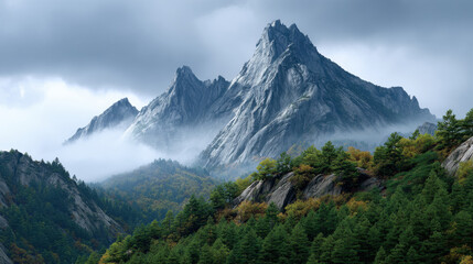 Majestic rocky mountain peak misty valley conifer forest dramatic cloud overcast sky autumn foliage