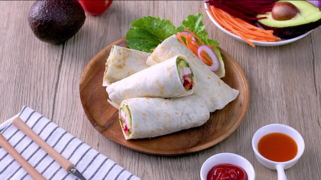 Chicken breast with caesar dressing and lettuce in a gluten-free tortilla wrap, tasty food