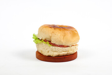 hamburger on round wooden board isolated on white background