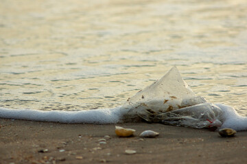 Plastic Waste Scattered on Beach Sand. Plastic waste on beaches is a serious global problem.