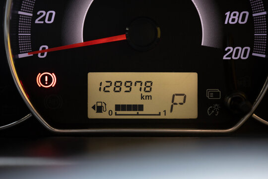Car instrument cluster showing speedometer, odometer, fuel gauge, warning light, and automatic gear indicator in modern vehicle dashboard - Powered by Adobe