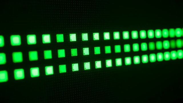 Green led lights on a dark background in a grid pattern