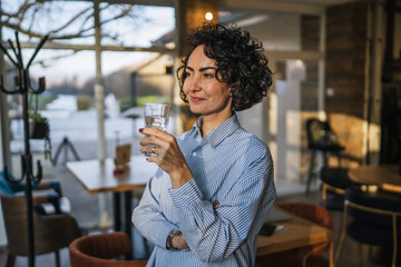 Woman drinking water enjoying a healthy break in cafe