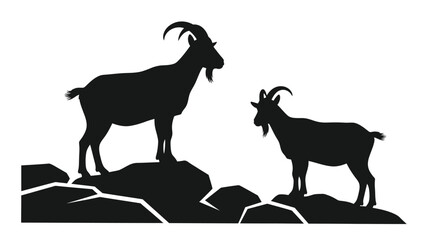 Two mountain goats standing on rocks a striking black silhouette