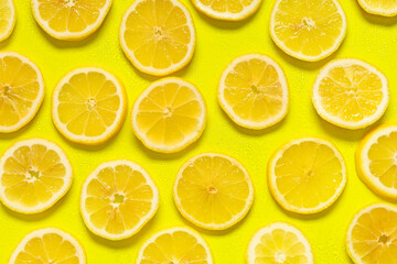 Fototapeta premium Composition with slices of fresh lemon on yellow background, closeup