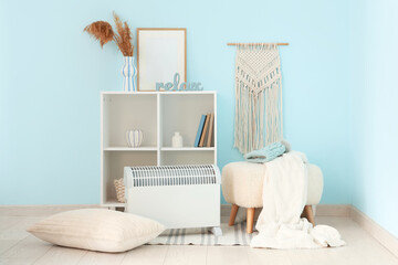 Interior of stylish living room with modern convector heater and white ottoman