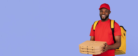 A cheerful delivery person in a red shirt and cap holds stacked pizza boxes with a yellow backpack slung over one shoulder. The background is a vibrant solid color, emphasizing the subject.