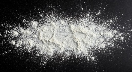 White flour or powdered sugar is abstractly scattered and dusted across a dark, textured black surface, creating a dynamic culinary background with fine particles.