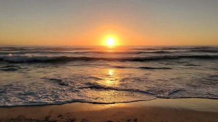 Golden Sunset Over Gentle Ocean Waves on a Sandy Beach.