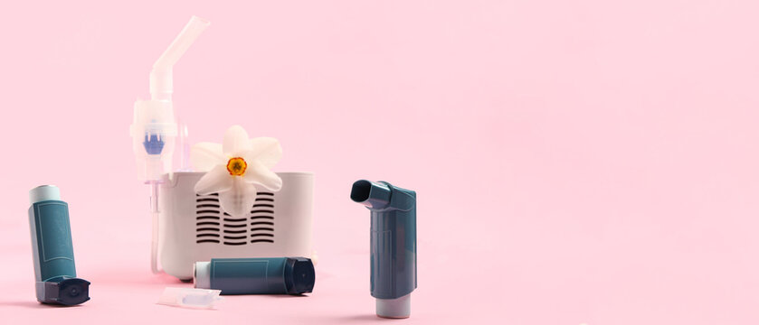 Modern inhalers and daffodil flower on pink background
