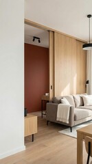 Modern living room with a beige sofa, wooden sliding door, and a warm red accent wall. Natural light illuminates the space, creating a cozy atmosphere.