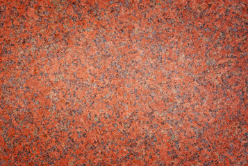 Natural red granite stone texture with detailed mineral pattern and rough polished surface. High resolution rock background with visible grains and speckles, suitable for architecture, construction