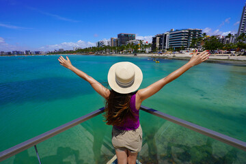 Fototapeta premium Holidays in Brazilian Caribbean. Beautiful tourist woman on belvedere in the city of Maceio, Alagoas, Brazil.