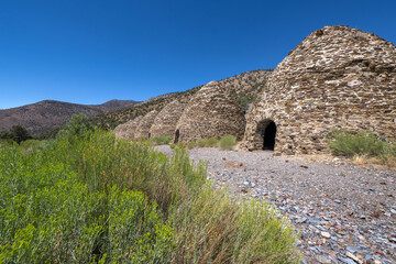 Row of Historic Charcoal Kilns Under Clear Blue Sky in Death Valley