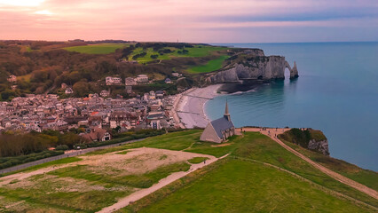 Aerial drone view of picturesque coastal limestone cliffs and the English Channel town of Etretat, France