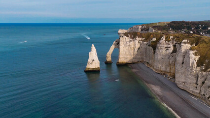 Aerial drone view of picturesque coastal limestone cliffs and the English Channel town of Etretat, France