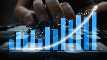 A close-up image of hands typing on a keyboard overlaid with graphs and charts representing business growth and analytics in a modern office environment. Copula