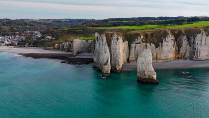 Aerial drone view of picturesque coastal limestone cliffs and the English Channel town of Etretat, France