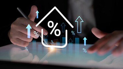 A business professional is analyzing financial growth trends on a touchscreen device. Graphs and symbols represent upward movement and percentage increase in a digital workspace. Gantry