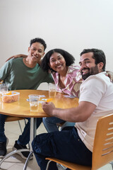 Group of friends playing cards together smiling