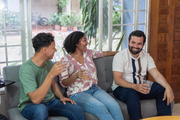 Friends enjoying conversation and drinks at home party