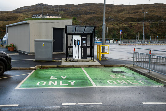 TARBERT, ISLE OF HARRIS, SCOTLAND &ndash; OCT 10, 2025: EV vehicle charging station at the ferry terminal, clean green energy transportation 
